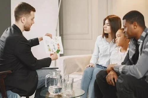 Therapist guiding family during family therapy Calgary session