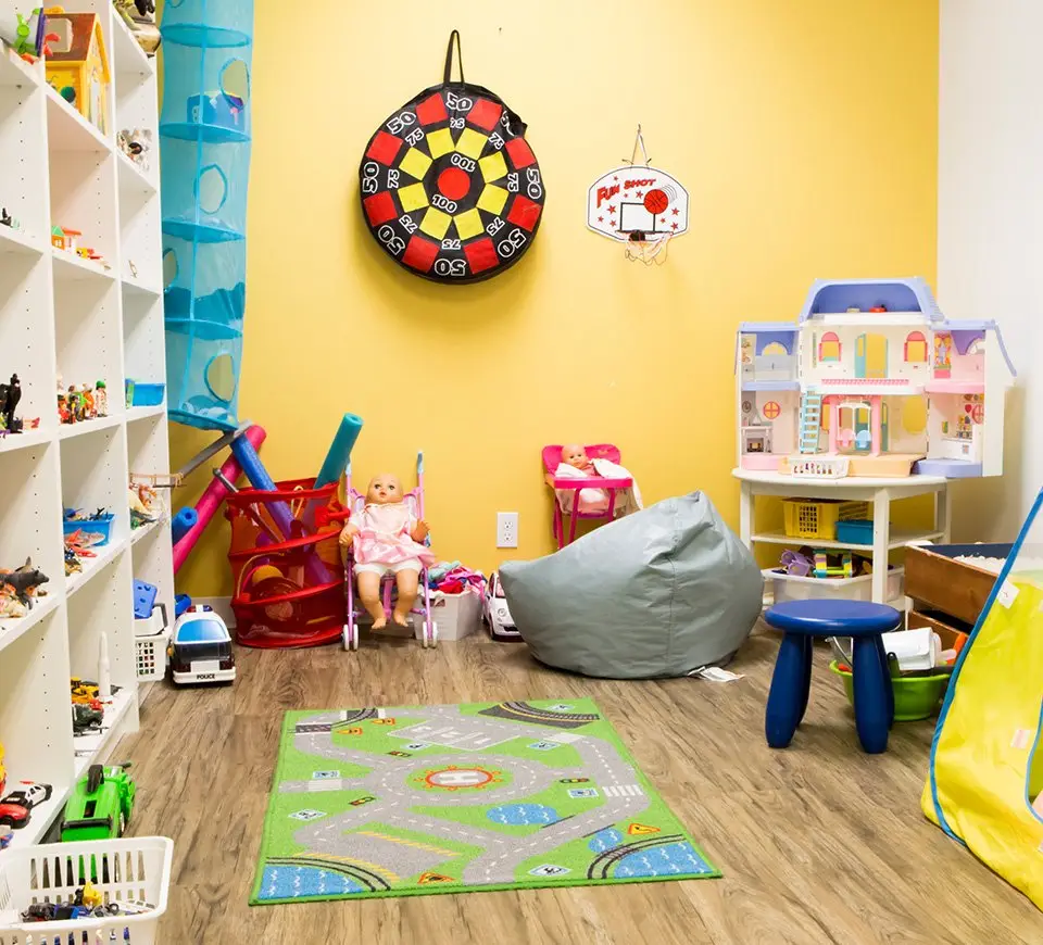 Play therapy room with colorful toys and educational games for kids